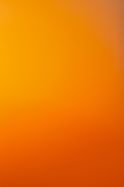 an airplane flying in the sky at sunset