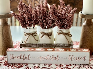 a couple of jars filled with flowers on top of a table