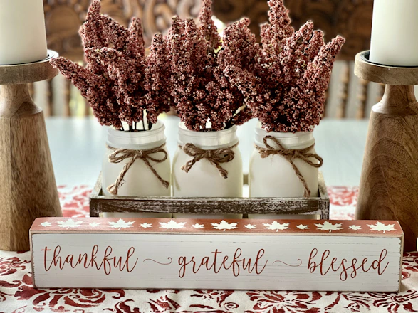 a couple of jars filled with flowers on top of a table