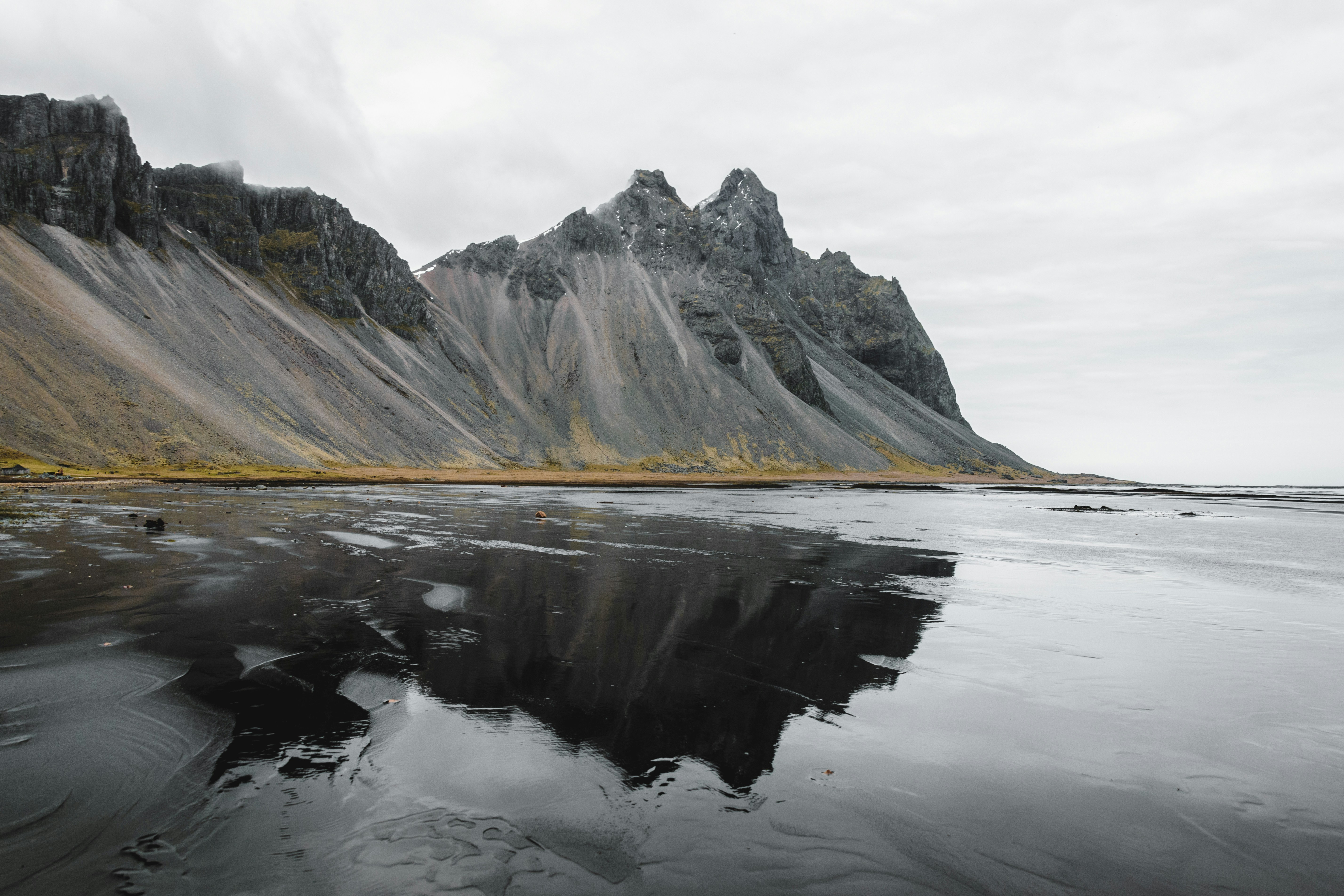 The peaks of Vestrahorn mountain viewed from its black sand beach in Iceland