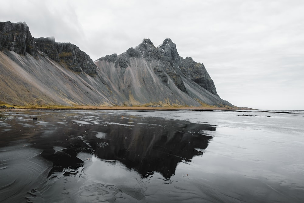 a body of water with a mountain in the background