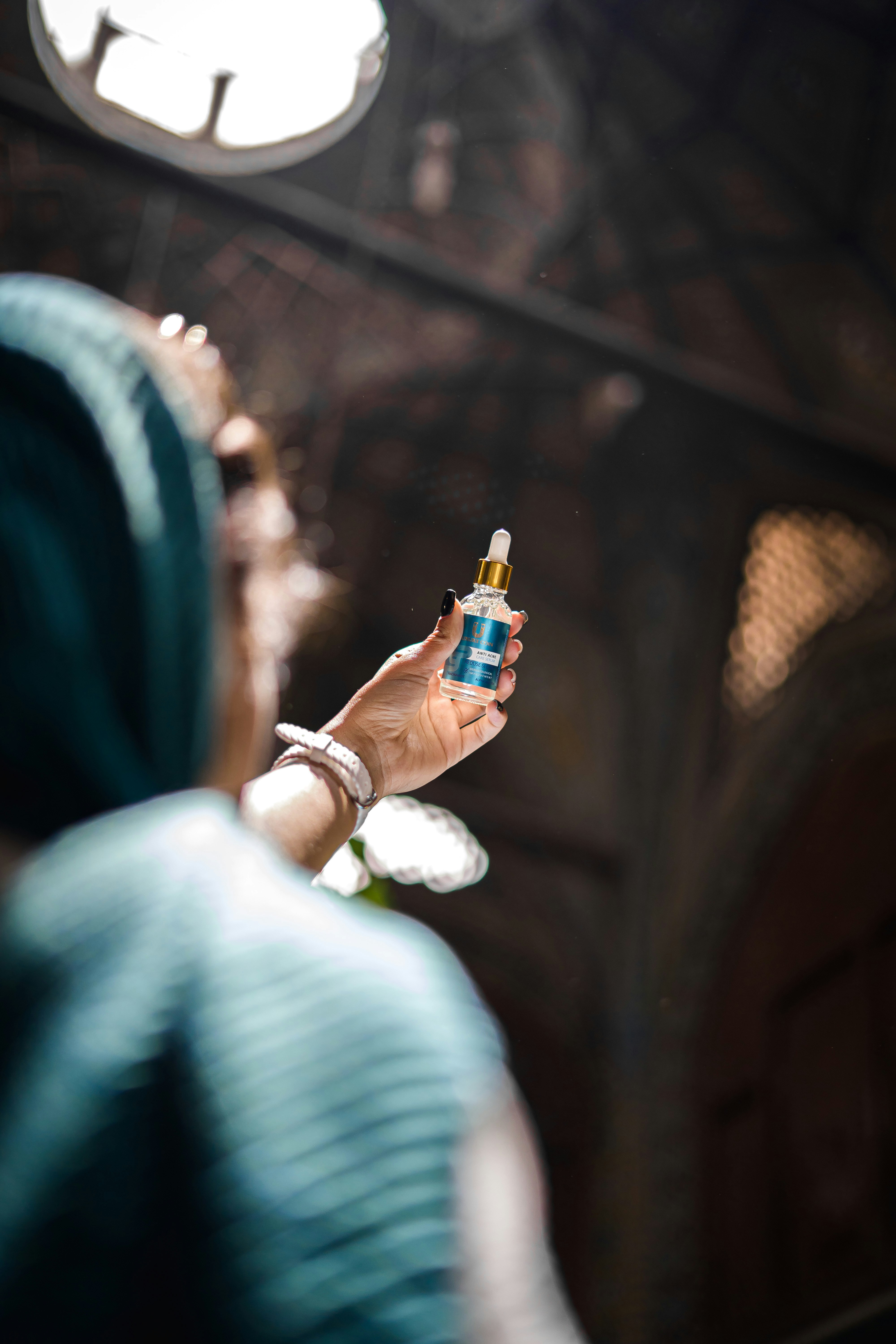 a woman holding a bottle of alcohol in her hand