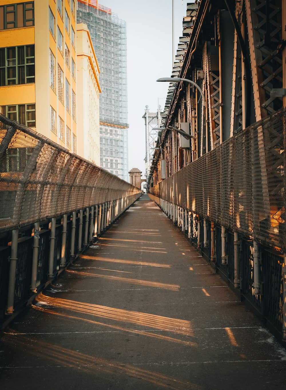 a long bridge with a building in the background