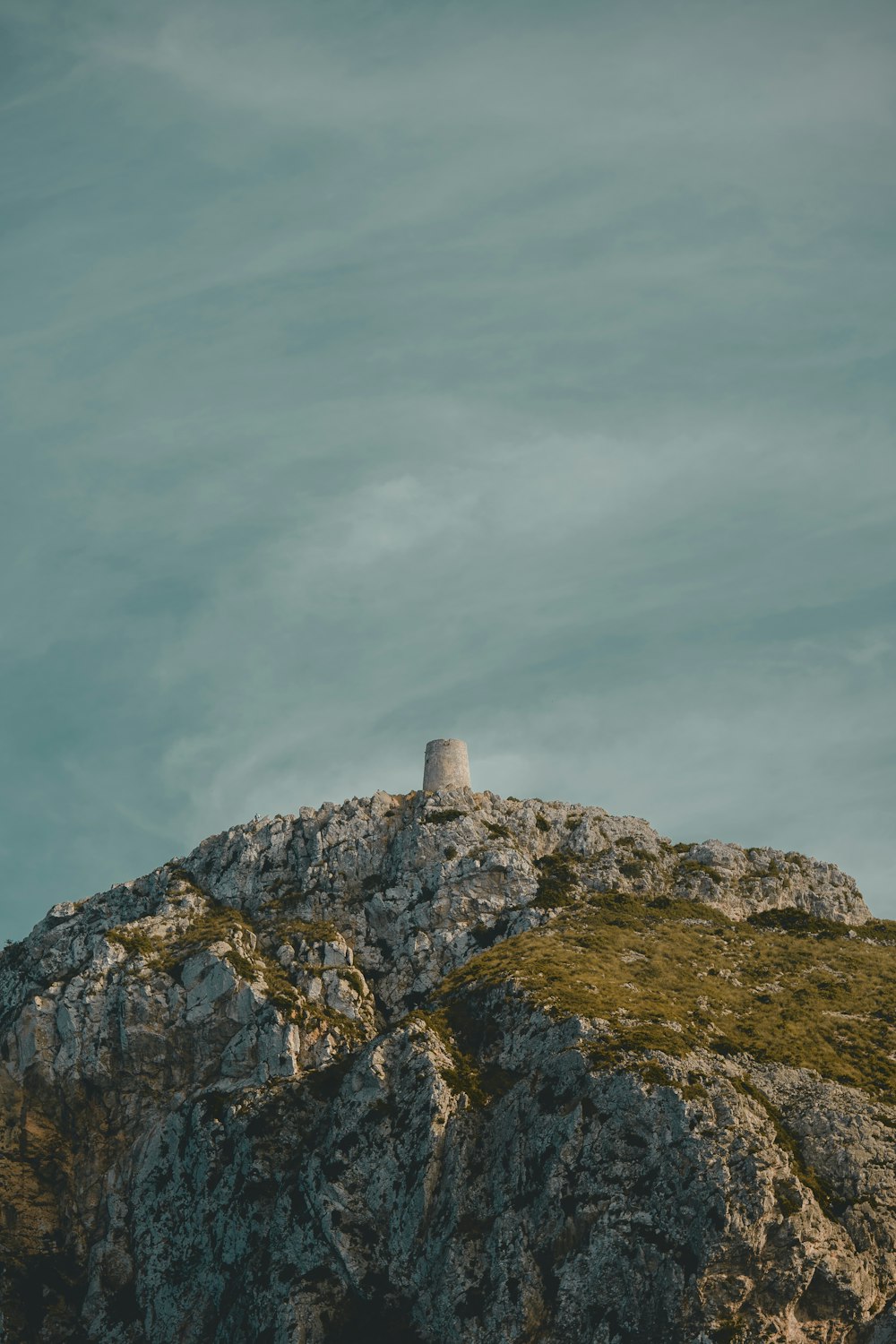 a rock outcropping with a tower on top of it