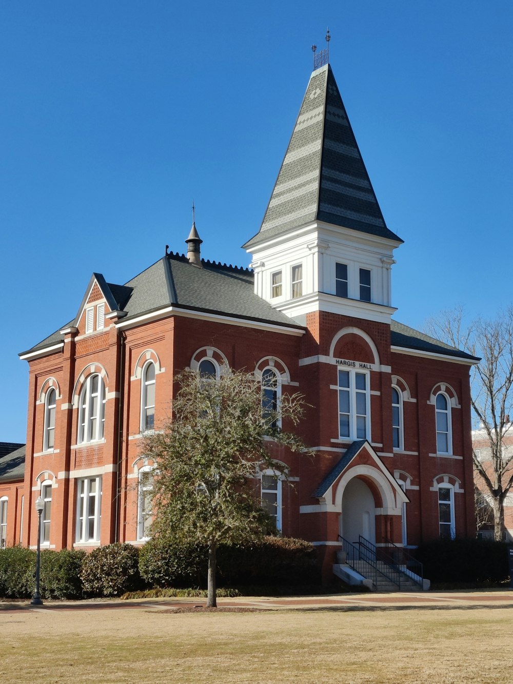 a large red brick building with a steeple on top