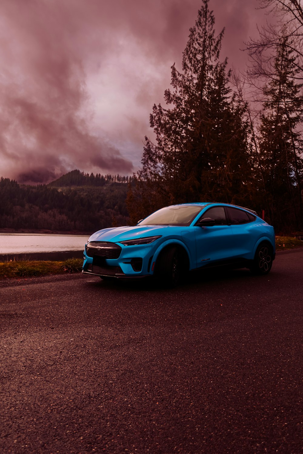 a blue sports car parked on the side of a road