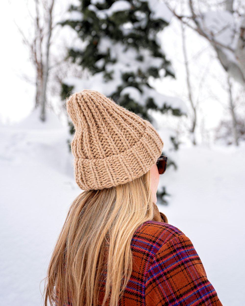 a woman wearing a knitted hat in the snow