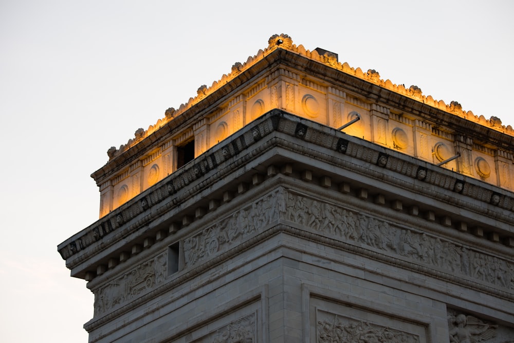 the top of a tall building with a clock on it