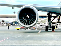Close-up of jet fuel being pumped into an aircraft at an airport.