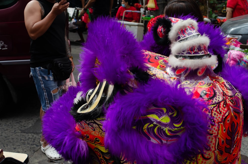 a purple and red dragon costume on a street