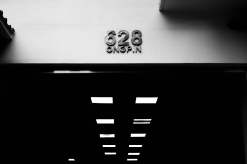 Black and white image of a crowded shelter entrance with bold green text.