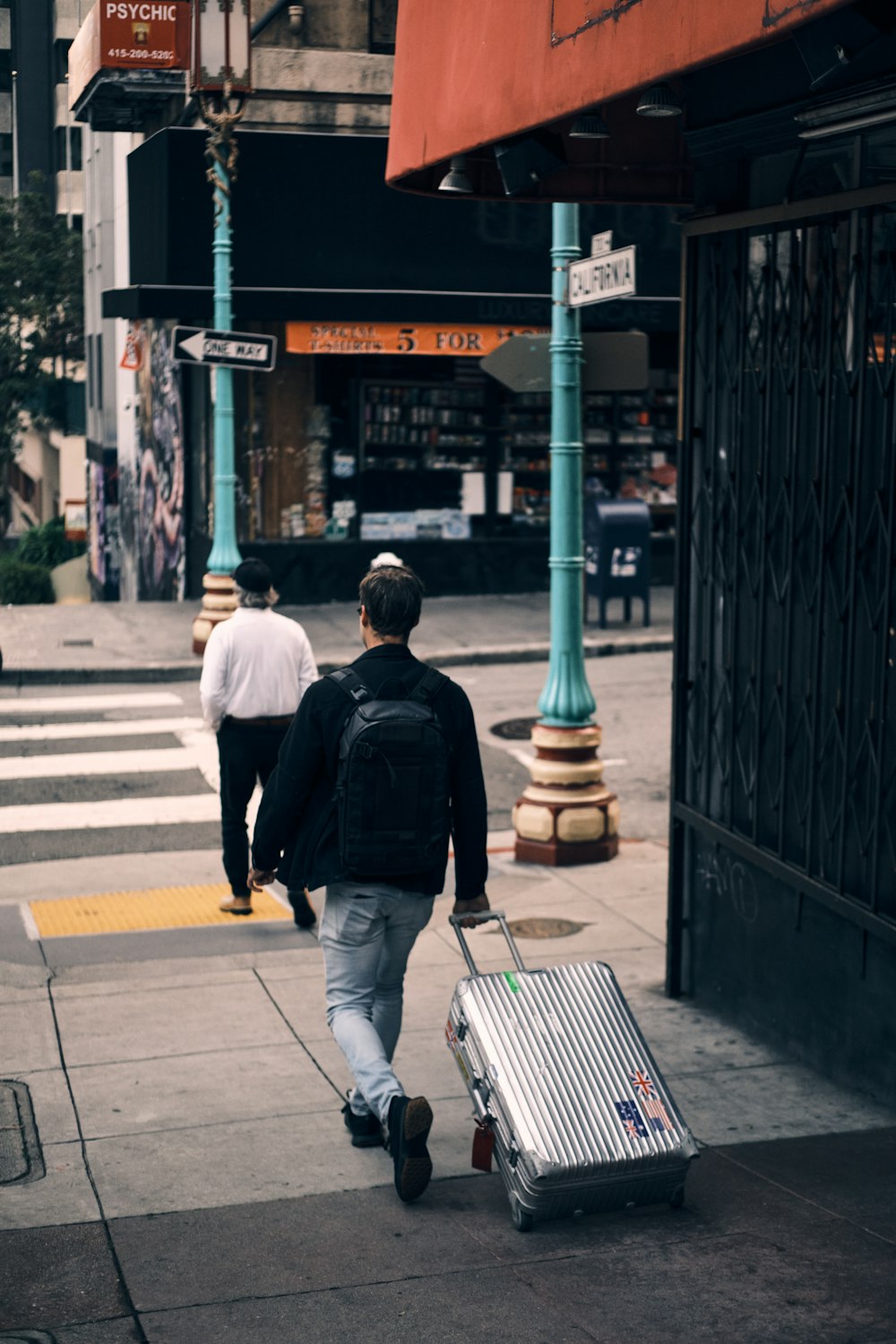 a man walking down the street with a suitcase