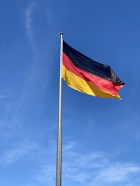 a german flag flying high in the sky