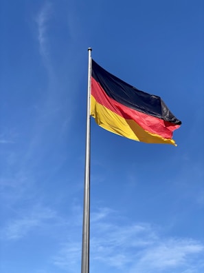 a german flag flying high in the sky