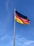 a german flag flying high in the sky