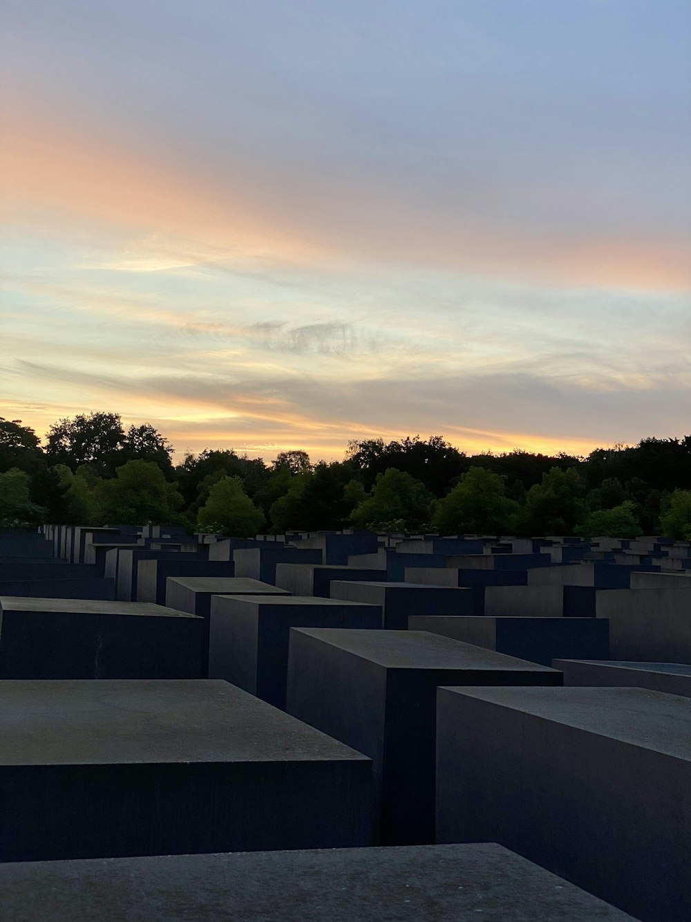 a large group of cement blocks with trees in the background