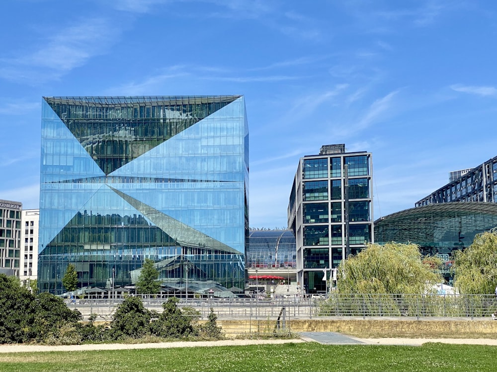 a large glass building sitting in the middle of a park