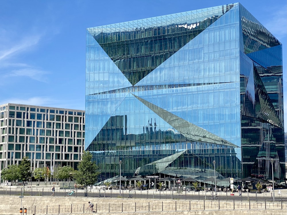 a large glass building with a triangular design on it