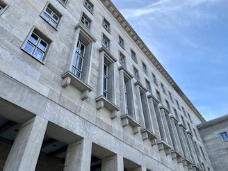 Wide angle of a facade with crown and belt cornices installed, emphasizing the lightweight EPS core and smooth coated finish.
