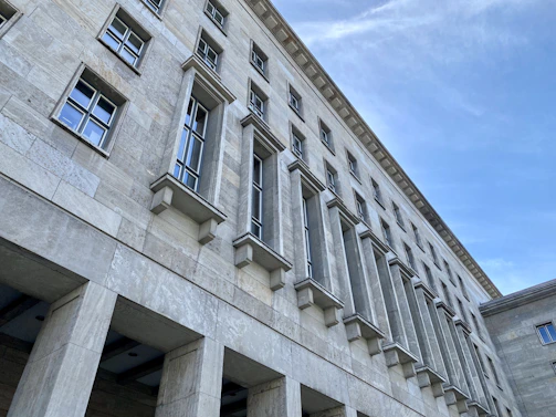 Wide angle of a facade with crown and belt cornices installed, emphasizing the lightweight EPS core and smooth coated finish.