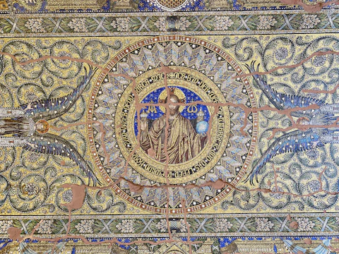 A swirling mosaic of ancient symbols from Greek, Georgian, and Scandinavian myths blending together.