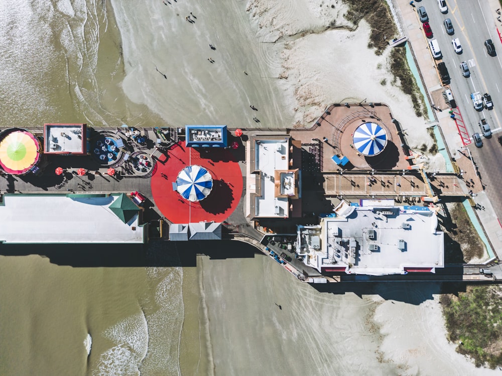 an aerial view of a pier with umbrellas on it
