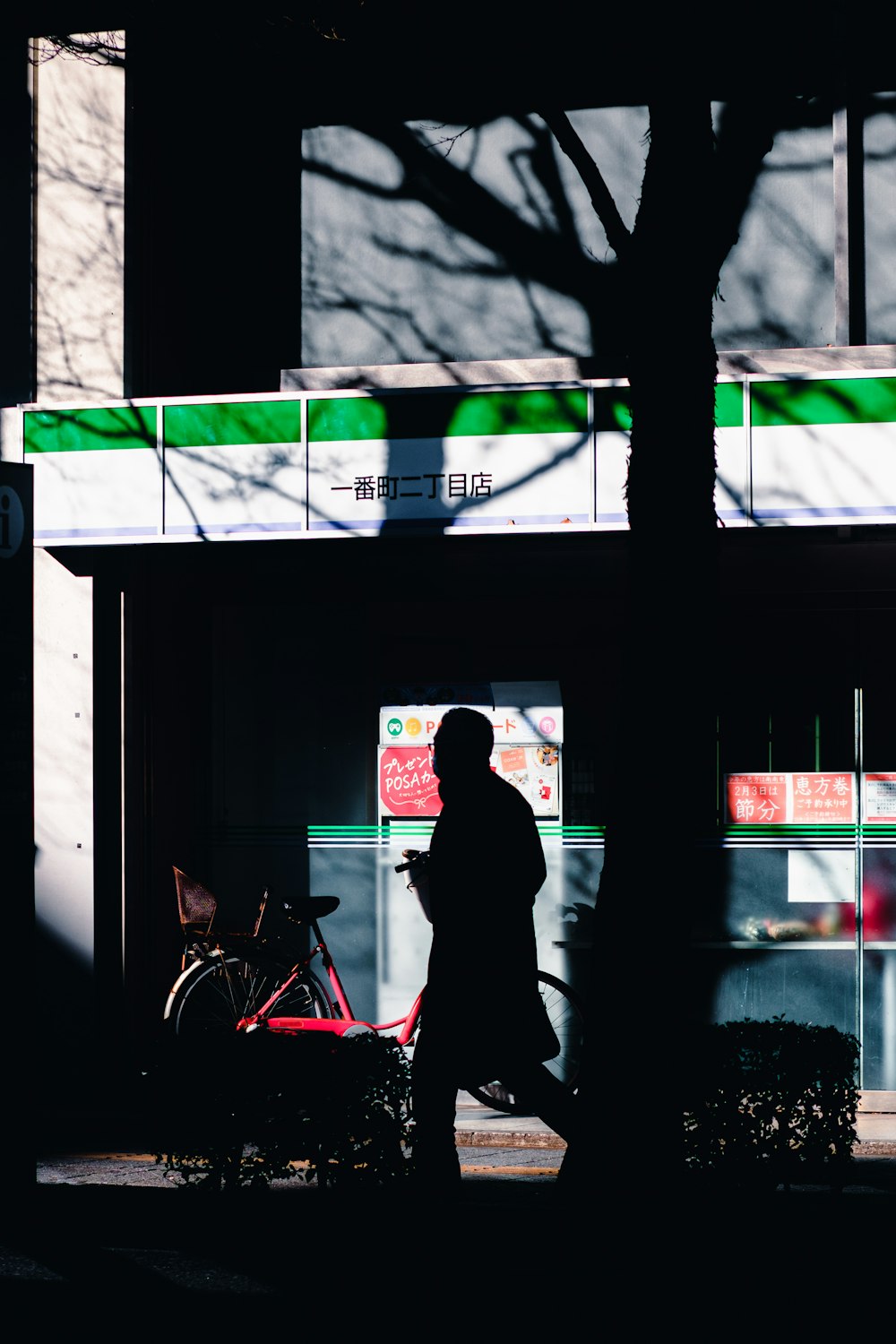 a person walking down a street past a building