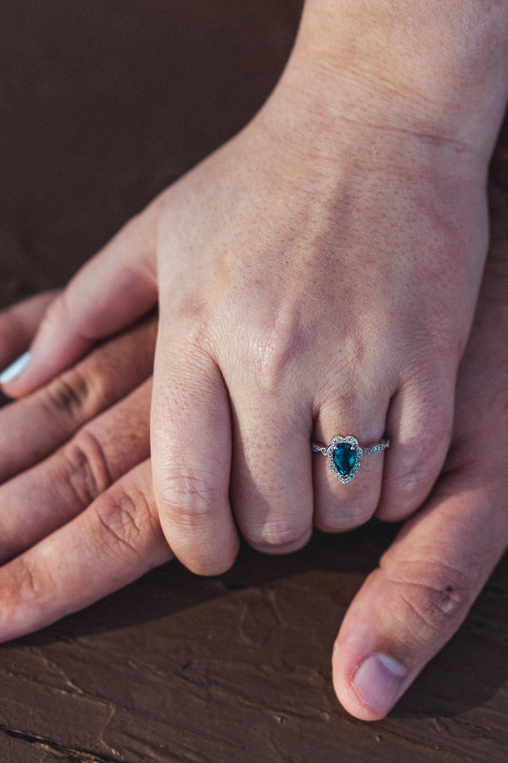 a close up of a person's hand with a ring on it