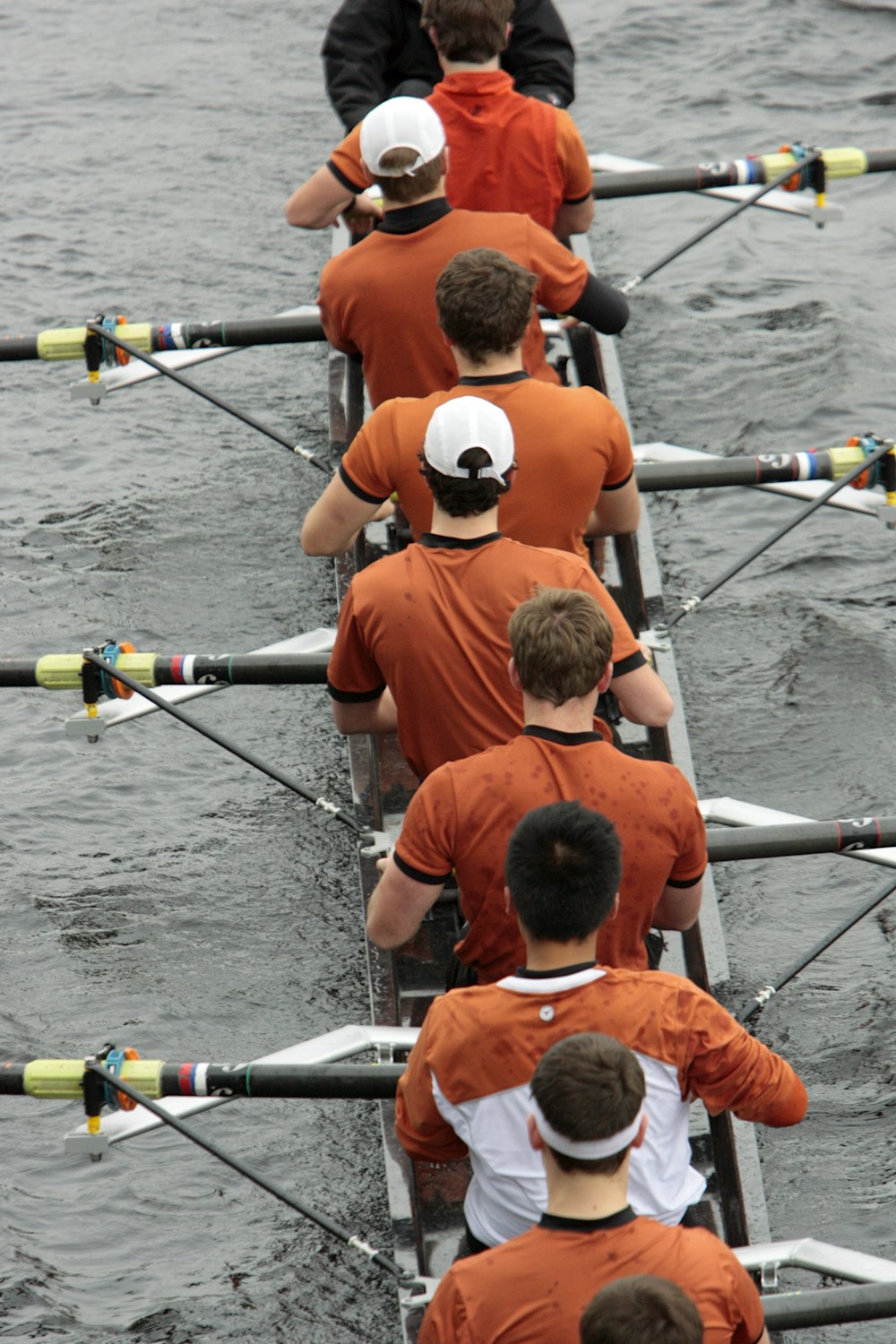 a group of men riding on the back of a boat