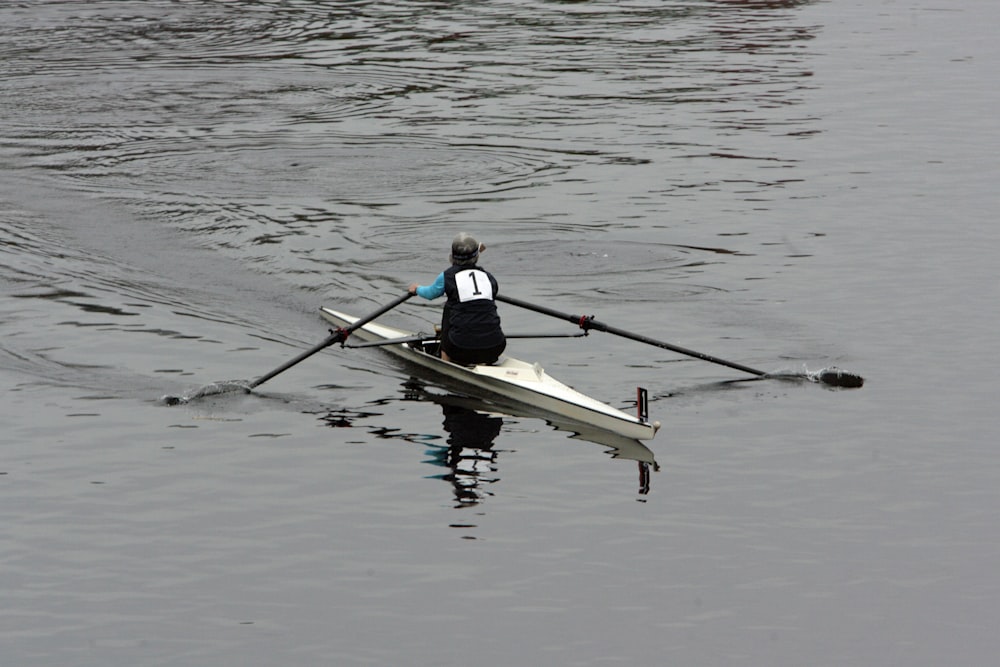 a person rowing a boat on a body of water