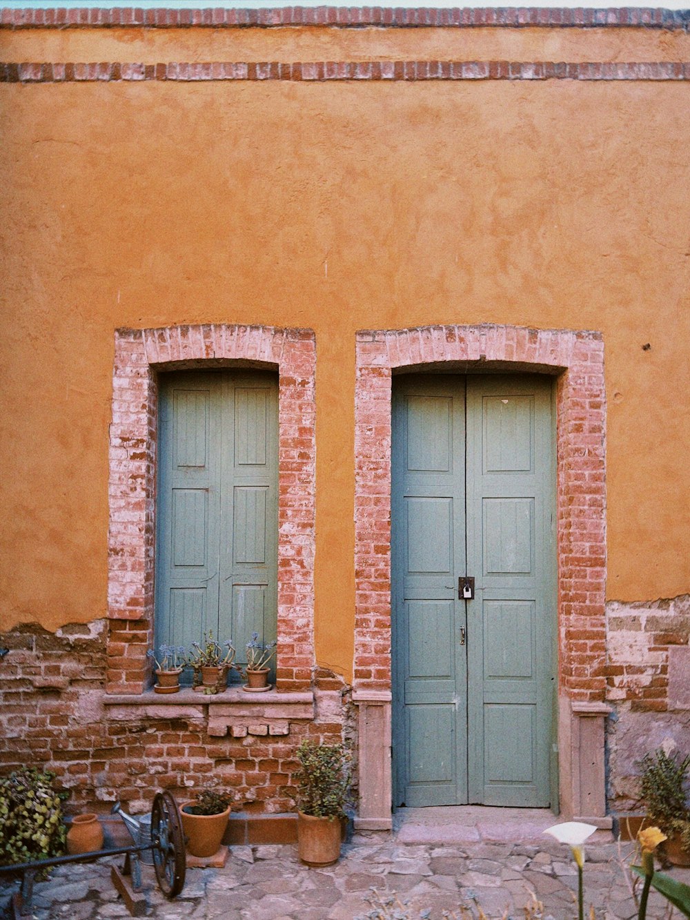 a couple of green doors sitting next to each other