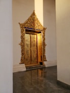 Close-up of a large, sturdy golden door with intricate detailing.