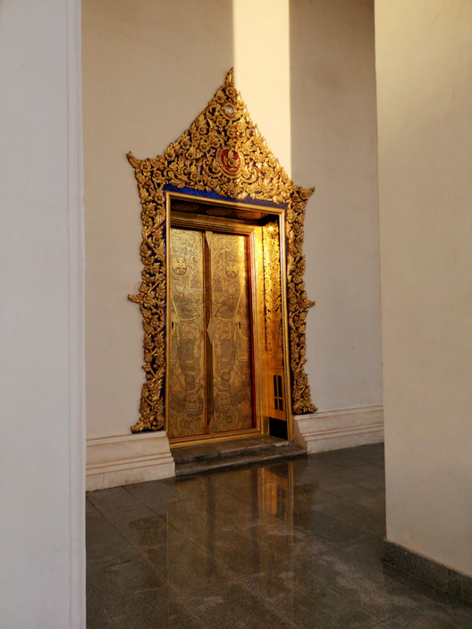Luxurious steel security door with gold accents, highlighting its sturdy frame and elegant design in a villa entrance.