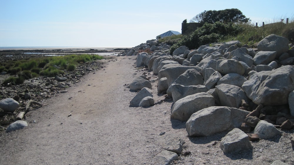 une route de gravier avec de gros rochers sur le côté