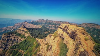 a view of a mountain range with a blue sky in the background