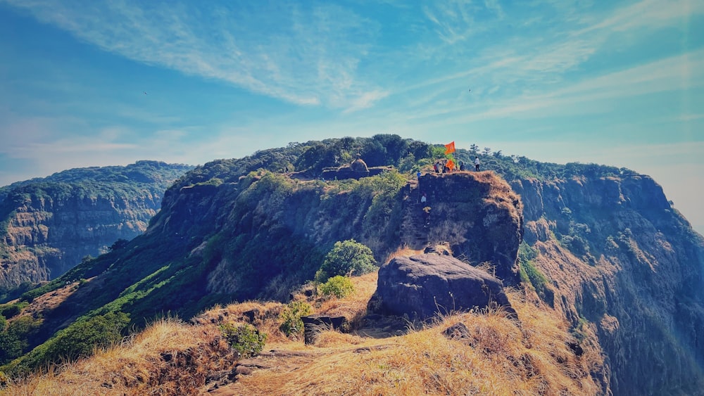 a person sitting on top of a large rock