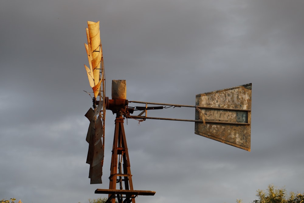 an old rusty windmill with a rusty sign on it