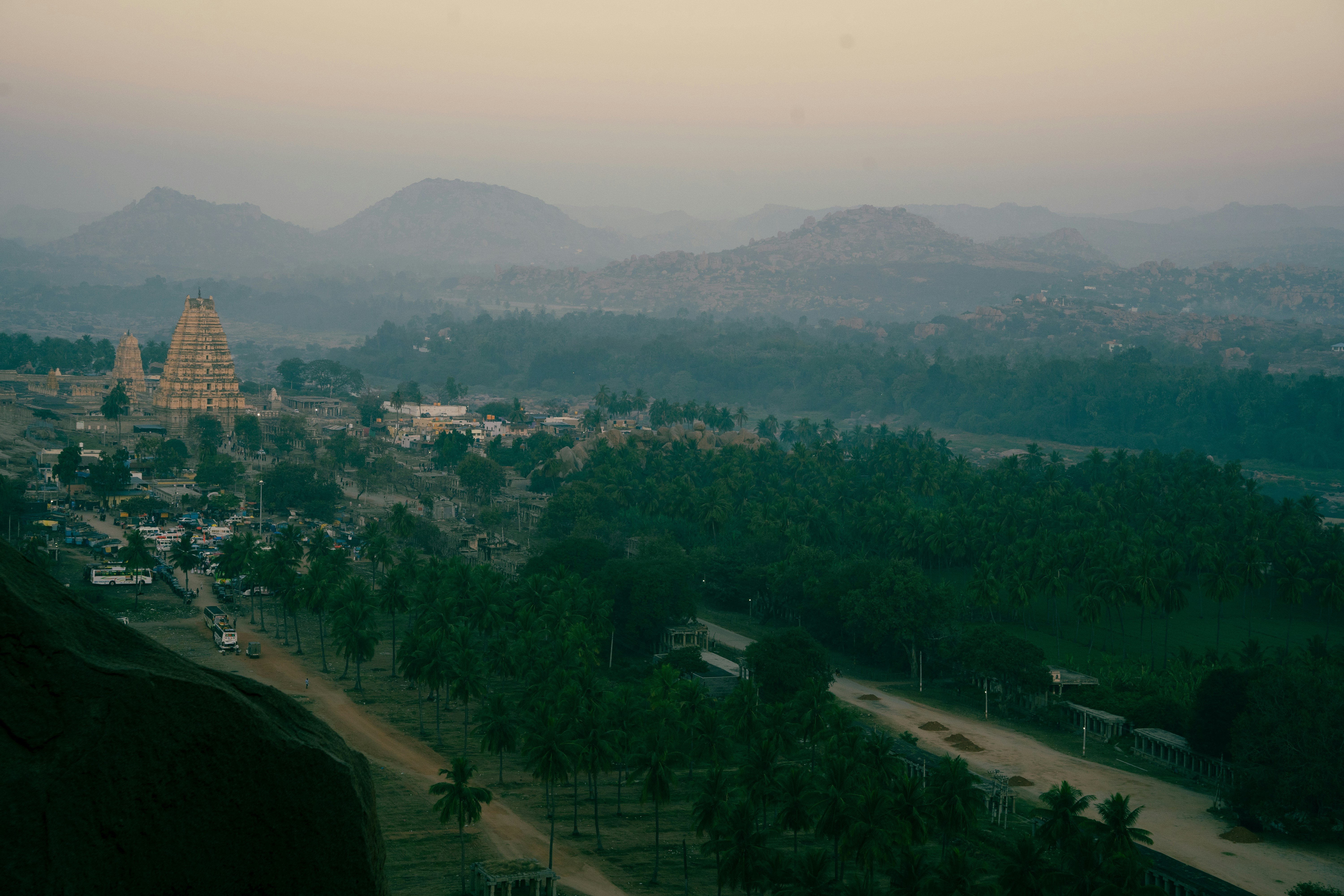 an aerial view of a city with mountains in the background