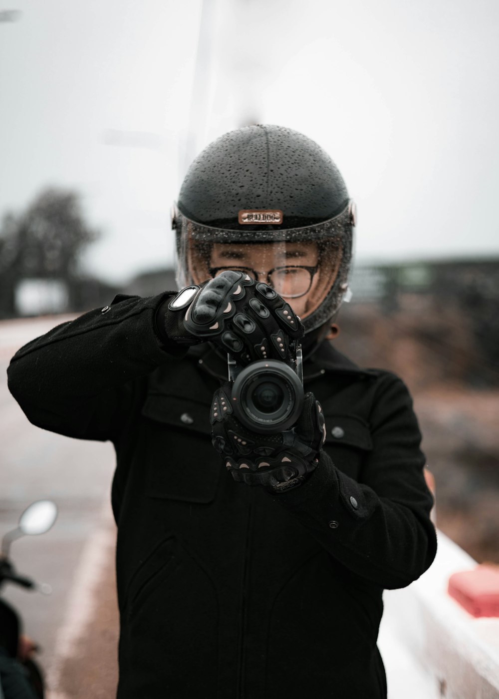 a person wearing a helmet and holding a camera