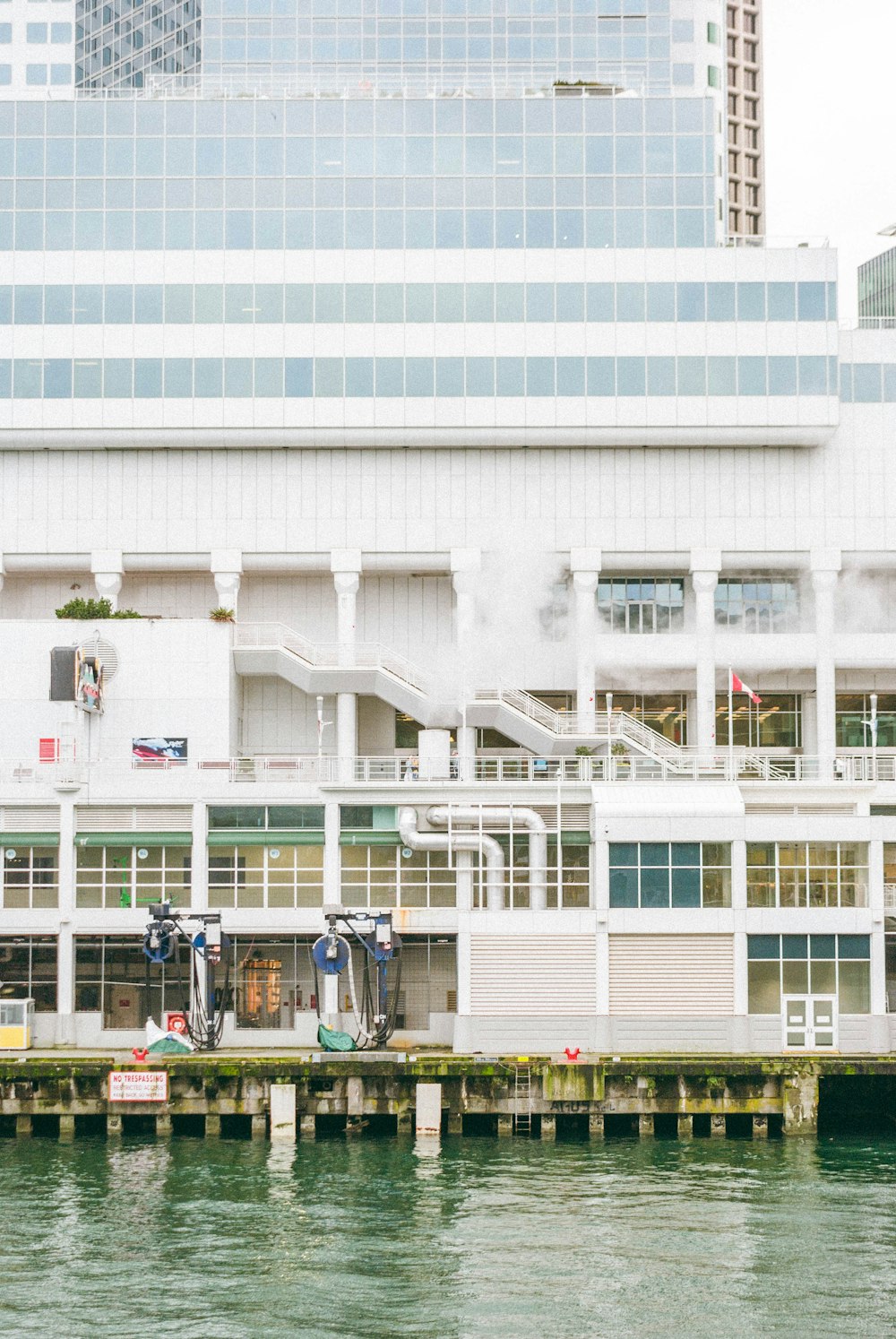 a large white building sitting next to a body of water