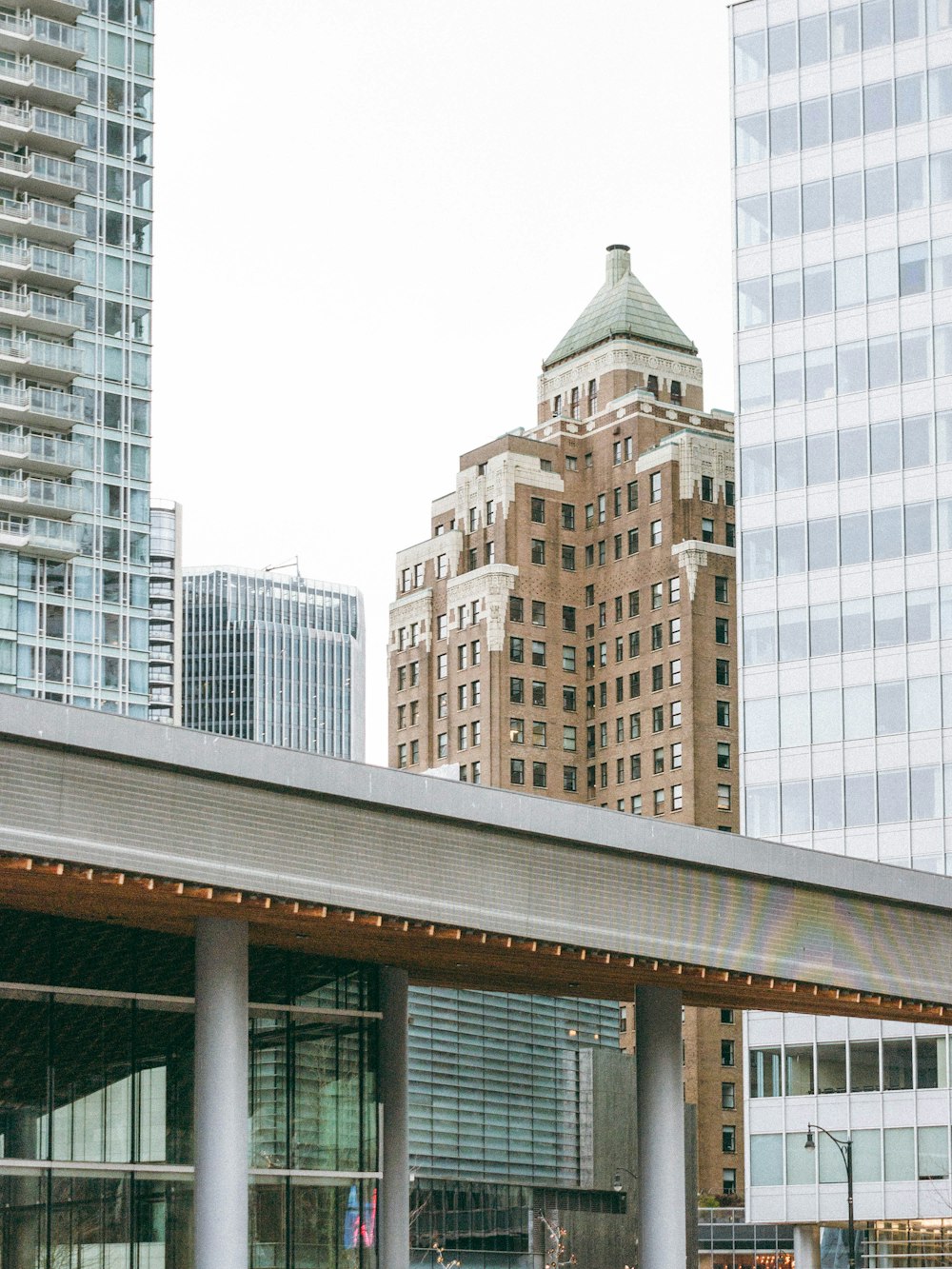 a train station in a city with tall buildings in the background