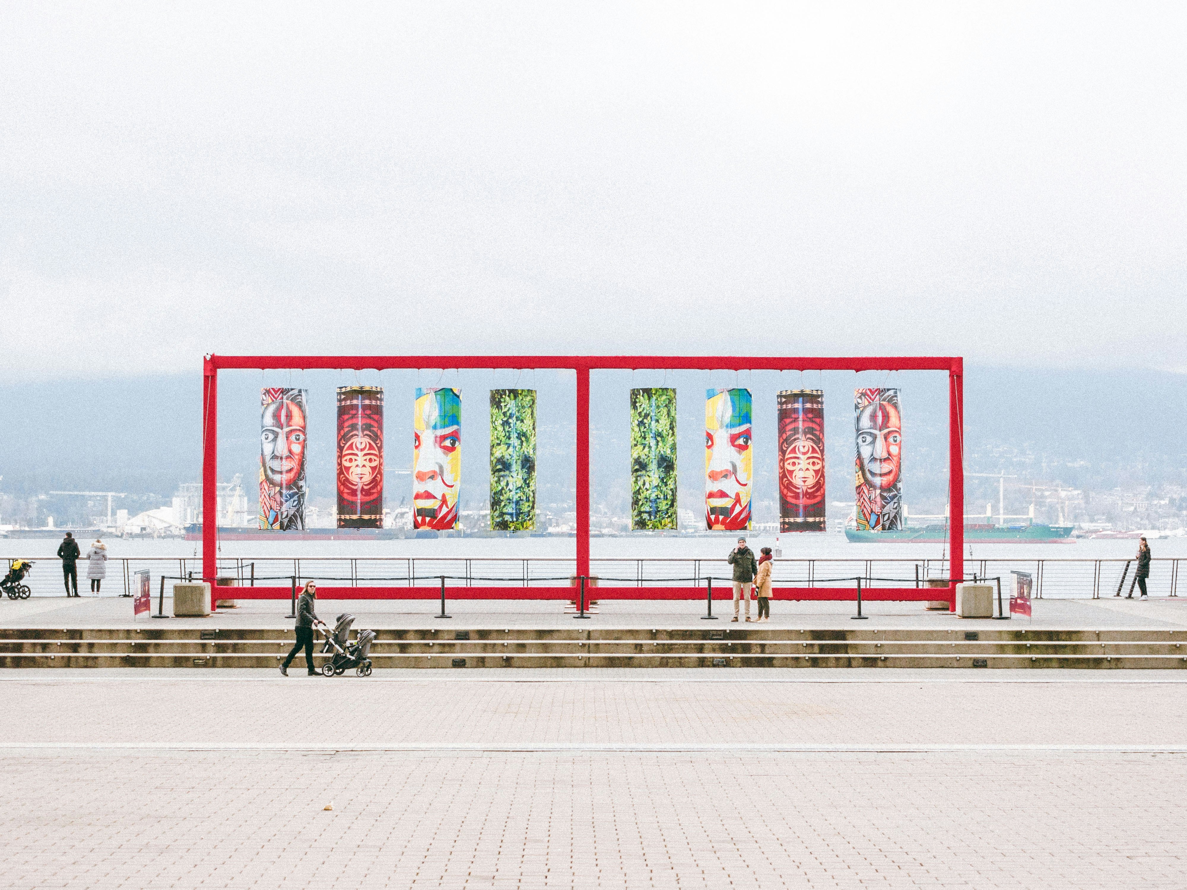 a group of people standing around a red structure