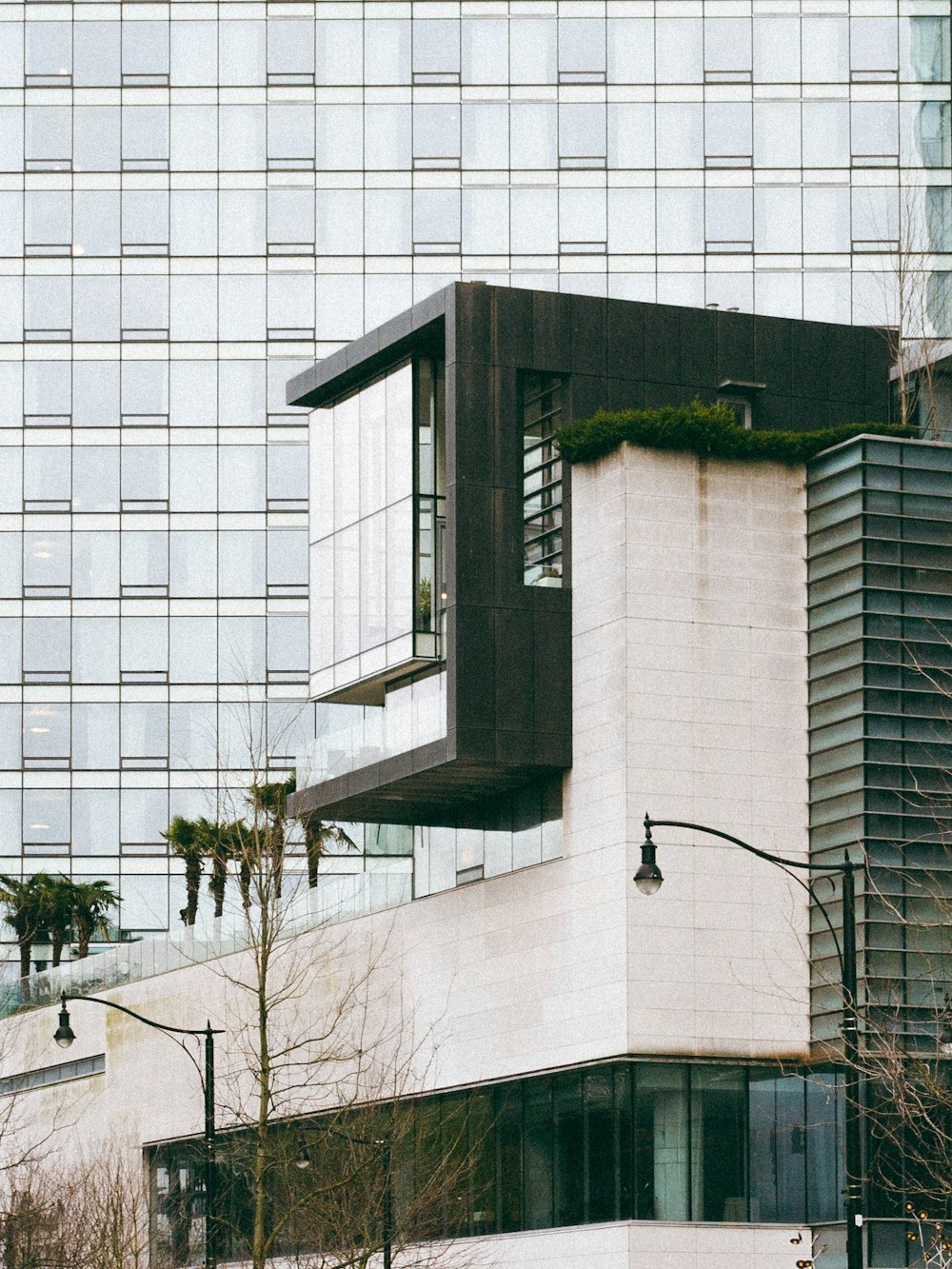 a tall white building sitting next to a tall building