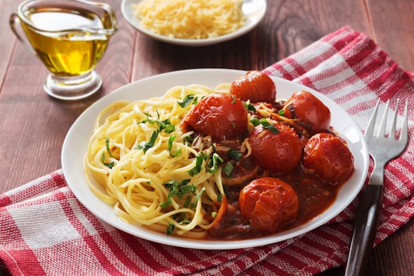 A plate of spaghetti with meatballs and sauce