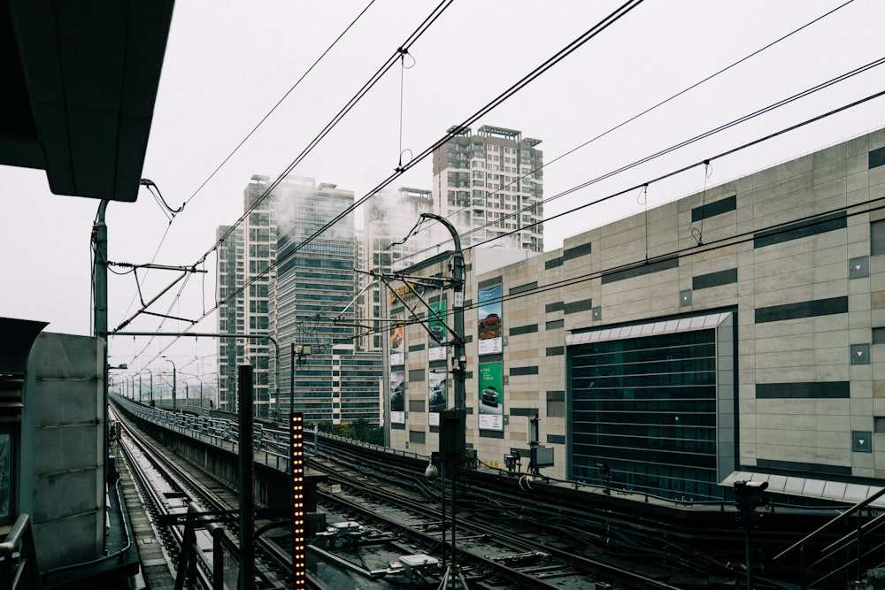 a view of a train track with buildings in the background