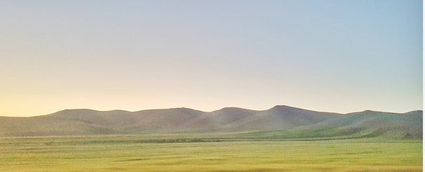 A serene landscape with a clear sky and open fields.