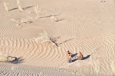 A team conducting a risk analysis meeting in a Sahel desert setting.