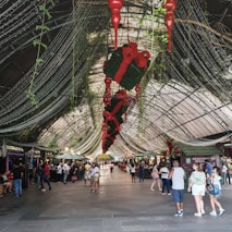 a group of people walking around a shopping mall