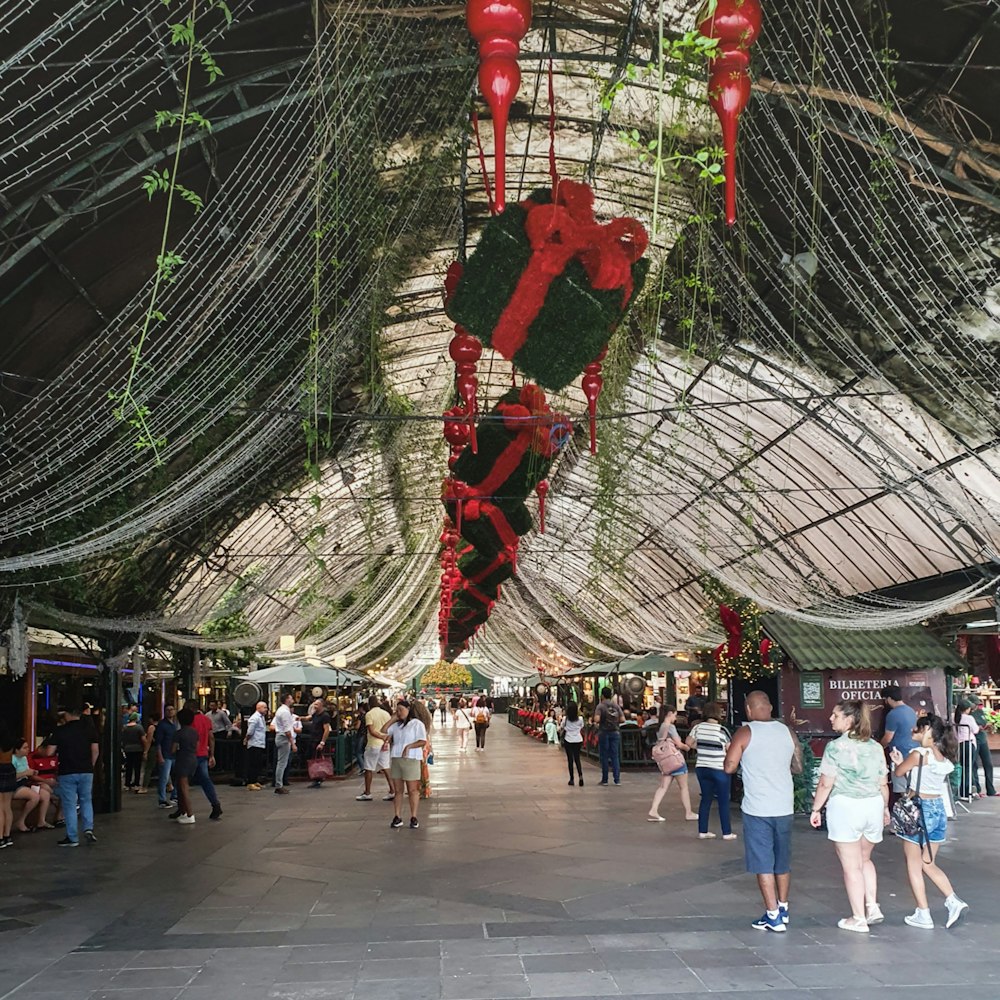 a group of people walking around a shopping mall