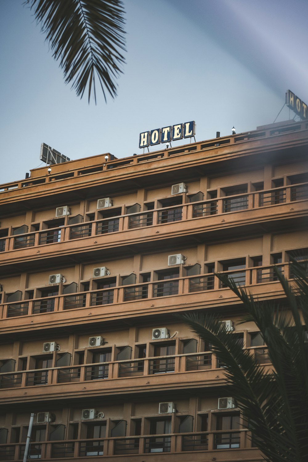 a hotel building with a palm tree in front of it